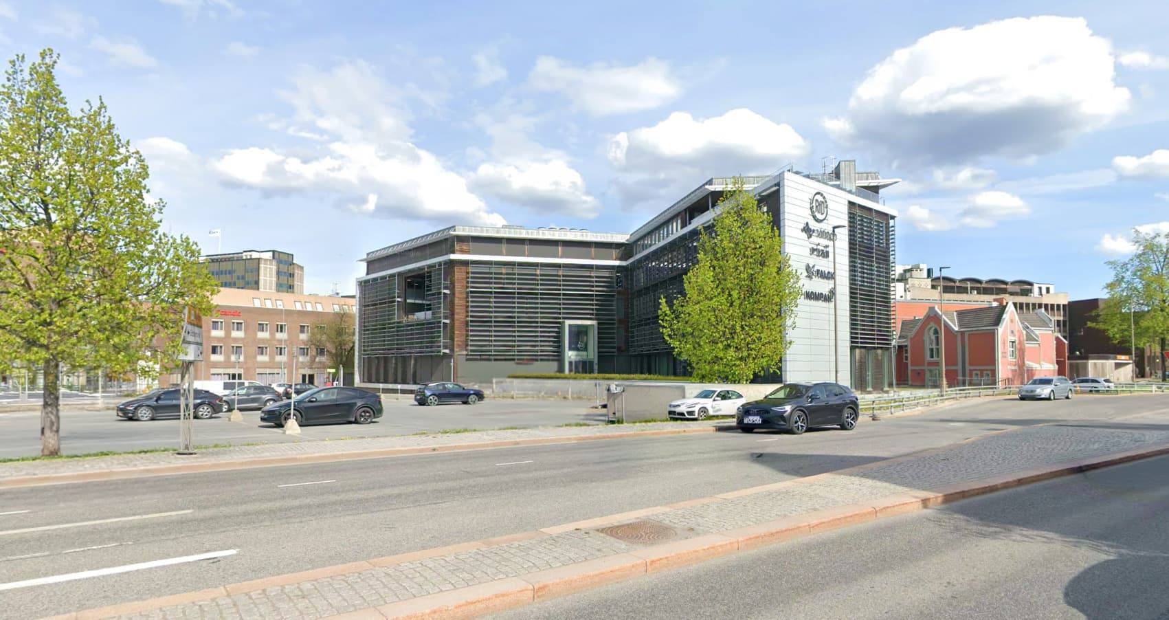 A wide street-level view of the Grønland 1 office building in central Drammen.