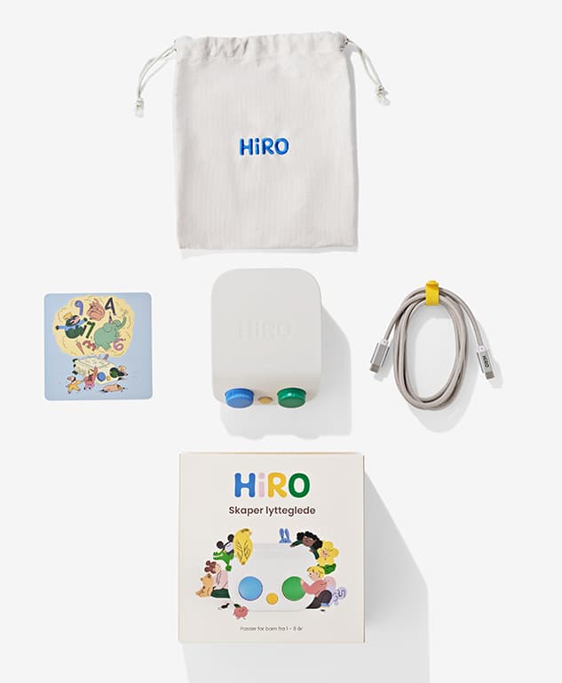 The HiRO starter kit laid out flat: a cloth carry pouch, a story card, the HiRO speaker, a USB charging cable and the retail box.