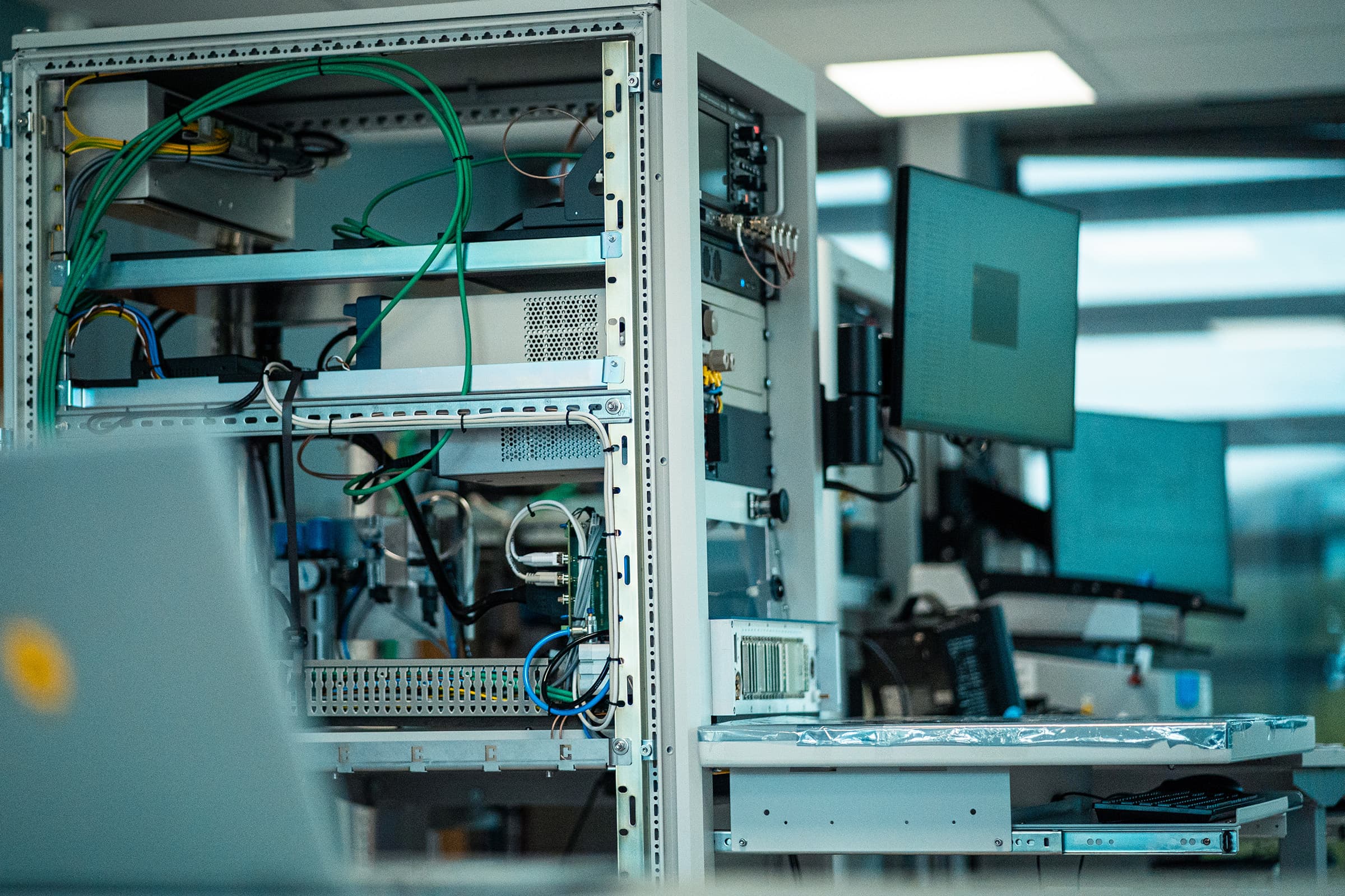 The inside of a Virinco test platform rack, showing the connector bay wiring and instrument bay.