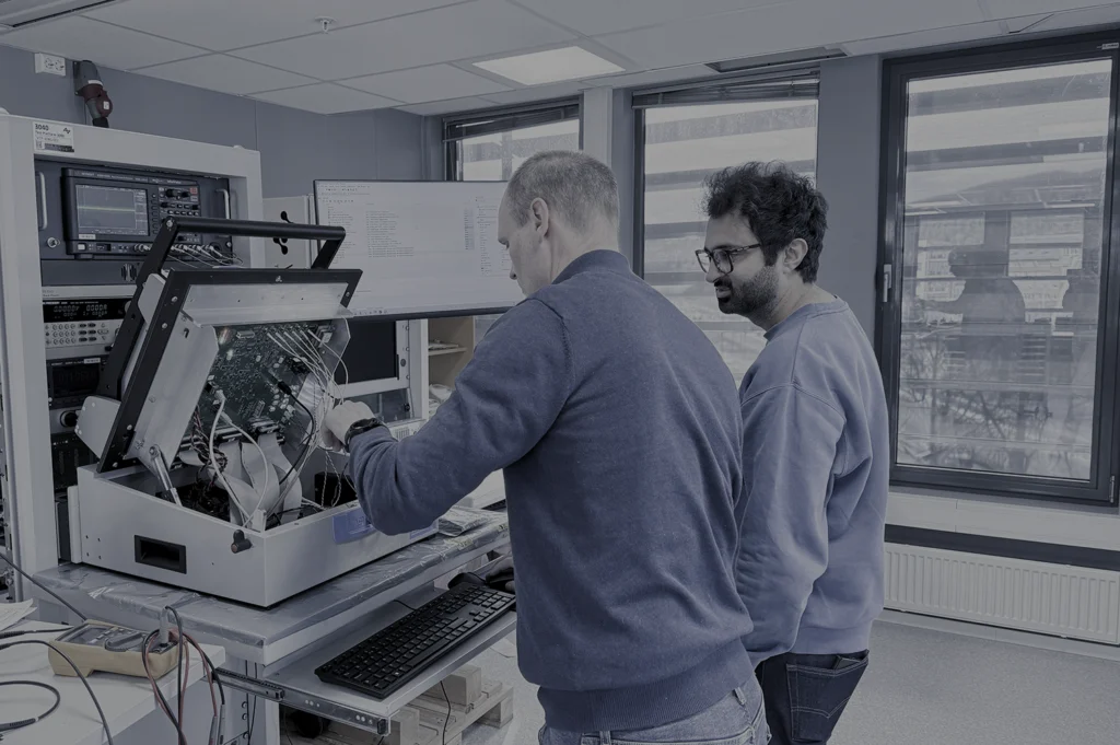 Engineers working on test fixture and PCBA during product development at Virinco